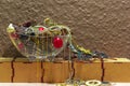 Mixed jewelry in a glass bathtub on top of wooden boxes