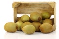 Mixed kiwi fruit in a wooden crate Royalty Free Stock Photo