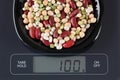 Mixed legume beans on kitchen scale Royalty Free Stock Photo