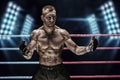 Mixed martial artist posing in the ring against spotlights. Concept of mma, ufc, thai boxing, classic boxing