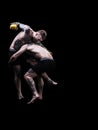 Mixed martial artists fighting on black background Royalty Free Stock Photo