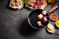 Mixed meat fondue with seasoning and dips Royalty Free Stock Photo