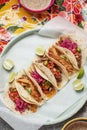 Mixed Mexican Tacos With Homemade Salsa, Limes And Parsley on bright traditional background.