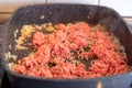 Mixed minced meat in a stainless steel pan shortly before being seared