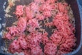 Mixed minced meat in a stainless steel pan shortly before being seared