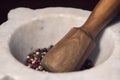 Mixed multi colored peppercorns in mortar and pestle. Close -up of Organic spices.