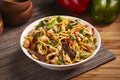 Mixed Noodles with vegetable, meat and chicken served in dish isolated on table side view of middle east food