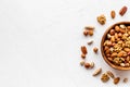 Mixed nuts in bowl - healthy snack - on white background top-down frame copy space Royalty Free Stock Photo