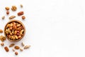 Mixed nuts in bowl - healthy snack - on white background top-down frame copy space Royalty Free Stock Photo