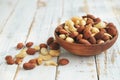 Mixed nuts in a bowl on a white wooden background. Royalty Free Stock Photo
