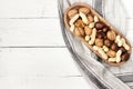 Mixed nuts in a bowl on a white wooden surface. Copy space Royalty Free Stock Photo