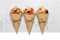 Mixed nuts and dried fruits in Retro Kraft Paper Cones on a light concrete background. Symbols of the Jewish holiday of Tu Bishvat