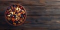 Mixed nuts and dried fruits in wooden bowl on wooden background. Healthy snack, mix of organic nuts and dry fruits Royalty Free Stock Photo