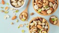 Mixed nuts healthy snack in wooden bowl on pastel blue background, top view Royalty Free Stock Photo