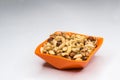 Mixed nuts in orange bowl isolated