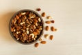 Mixed nuts in a metal bowl on a white wooden background. Royalty Free Stock Photo