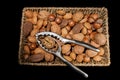 Mixed nuts with nutcracker in wicker basket Royalty Free Stock Photo