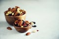 Mixed nuts and raisins in wooden bowl. Healthy food and snack. Walnut, pistachios, almonds, hazelnuts, cashews, raisins Royalty Free Stock Photo