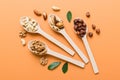 mixed nuts in white wooden spoon. Mix of various nuts on colored background. pistachios, cashews, walnuts, hazelnuts Royalty Free Stock Photo