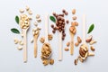 mixed nuts in white wooden spoon. Mix of various nuts on colored background. pistachios, cashews, walnuts, hazelnuts, peanuts and Royalty Free Stock Photo