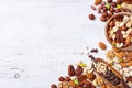 Mixed nuts on white wooden table top view. Healthy food and snack