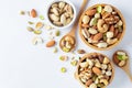 Mixed nuts in wooden bowl with spoon on white background, top view Royalty Free Stock Photo