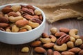 Mixed nuts on wooden table and bowl Royalty Free Stock Photo