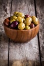 Mixed olives in a bowl on a rustic table Royalty Free Stock Photo