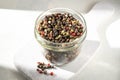 Mixed pepper corn. Black, red and white peppercorns in a glass jar. Royalty Free Stock Photo