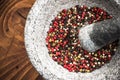 Mixed peppercorn seeds in granite pestle or mortar