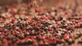 Mixed peppercorns falling on wooden table, 240 fps slow motion