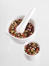 Mixed peppercorns in a porcelain mortar