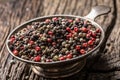 Mixed peppercorns red black and white in bowl - Close-up