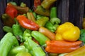 Mixed peppers tumble from farm crate