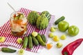 Mixed pickle jar with unripe,pickled vegetables on white background