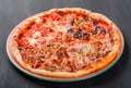 Mixed pizza Italian food with chicken, tomatoes, mushrooms, ham, salami, olive and cheese Royalty Free Stock Photo