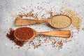 Mixed quinoa in spoons on wooden kitchen table top view. Royalty Free Stock Photo