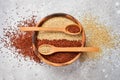 Mixed quinoa in spoons on wooden kitchen table top view. Royalty Free Stock Photo