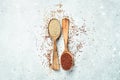 Mixed quinoa in spoons on wooden kitchen table top view. Royalty Free Stock Photo