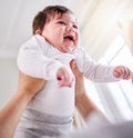 a mixed race adorable cute little baby laughing. Young mother playing with her newborn baby while laughing and enjoying Royalty Free Stock Photo