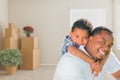 Mixed Race African American Father and Son In Room with Packed M Royalty Free Stock Photo