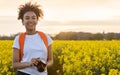 Mixed Race African American Girl Teenager With Camera in Yellow Flowers Royalty Free Stock Photo