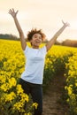 Mixed Race African American Girl Teenager Celebrating In Yellow Flowers Royalty Free Stock Photo