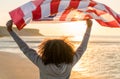 Mixed Race African American Girl Teenager With US Flag on Beach Royalty Free Stock Photo