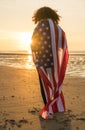 Mixed Race African American Girl Woman Wrapped in US Flag Beach Royalty Free Stock Photo