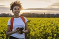 Mixed Race African American Teenager Woman With Camera in Yellow Flowers Royalty Free Stock Photo