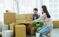 Mixed race Asian Caucasian adorable cute couple helping each other to move new house, carrying and arranging carton paper Royalty Free Stock Photo