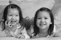 Mixed race Asian toddlers smiling at camera