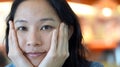 Mixed race Asian woman looking at camera with natural skin tone