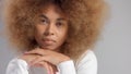 Mixed race black woman with big afro hair in studio put a cream smudge Royalty Free Stock Photo